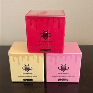 3 Honeybalm natural lip balms. Cherry, Strawberry, and Honey